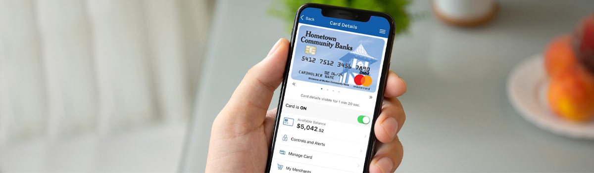 Smartphone with Hometown Banks debit card management screen shown 