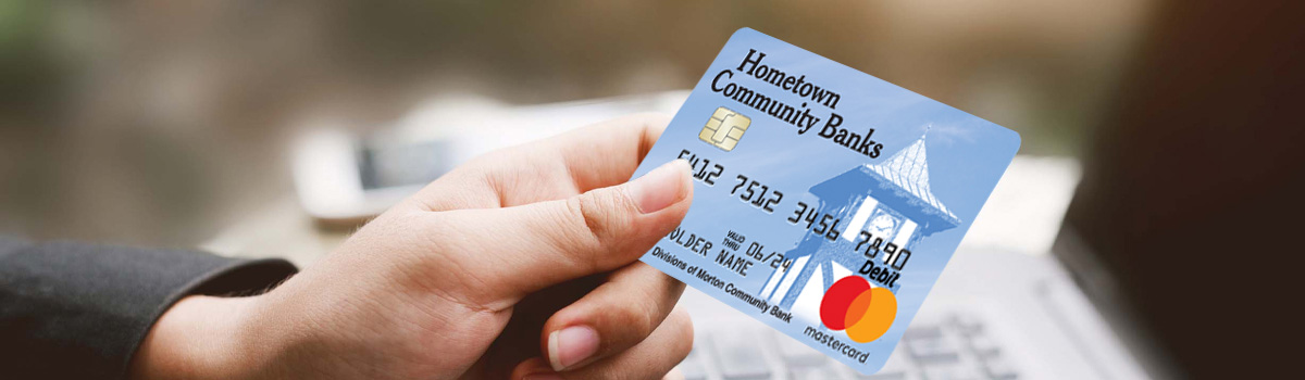 Close up of Hometown Banks Debit Card held in a woman's hand 