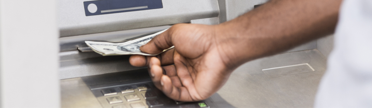 A person withdrawing money from an ATM machine.