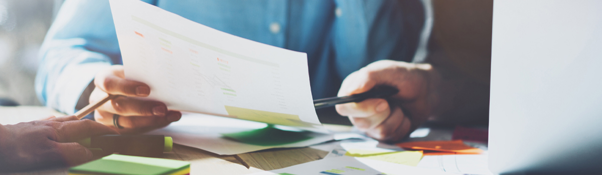 Lender showing customer information on paper by pointing with pen