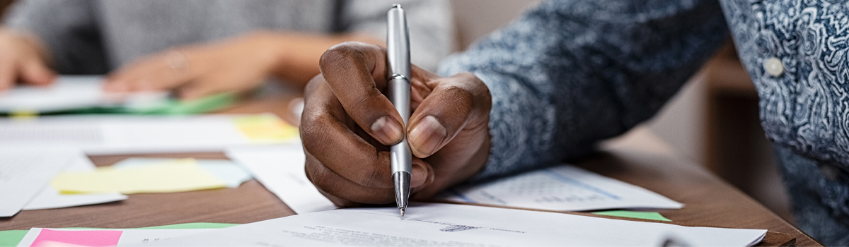 person signing business papers at Bank